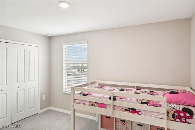 unfurnished bedroom with light colored carpet and a closet