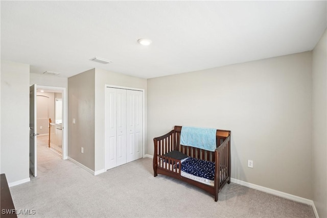 carpeted bedroom with a closet