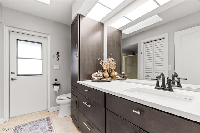 bathroom featuring vanity, an enclosed shower, and toilet