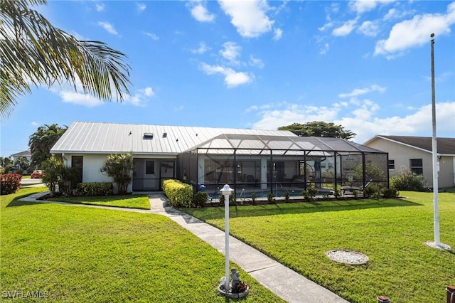 exterior space with a front yard and glass enclosure