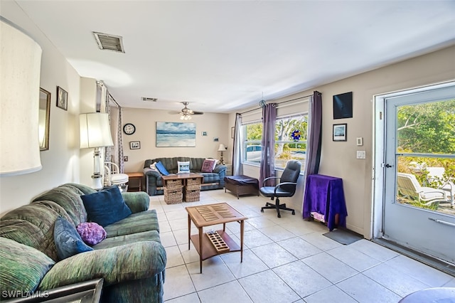 tiled living room with ceiling fan