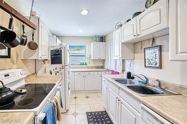 kitchen with light tile patterned flooring, sink, white cabinets, and white appliances