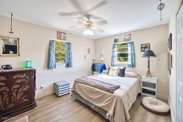 bedroom with ceiling fan and light hardwood / wood-style flooring