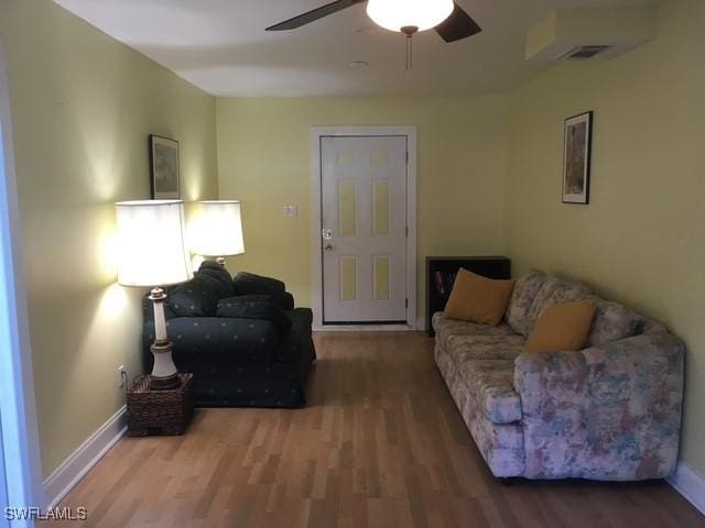 living room with ceiling fan and wood-type flooring