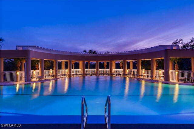 view of pool at dusk