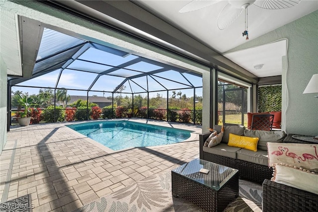 view of swimming pool featuring an outdoor living space, a patio, a lanai, and ceiling fan