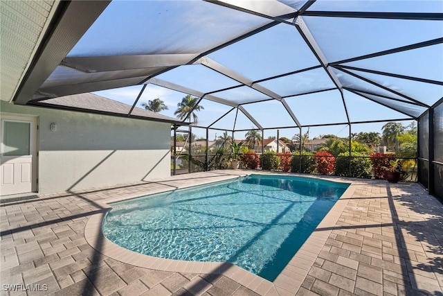 view of swimming pool with a patio area and glass enclosure