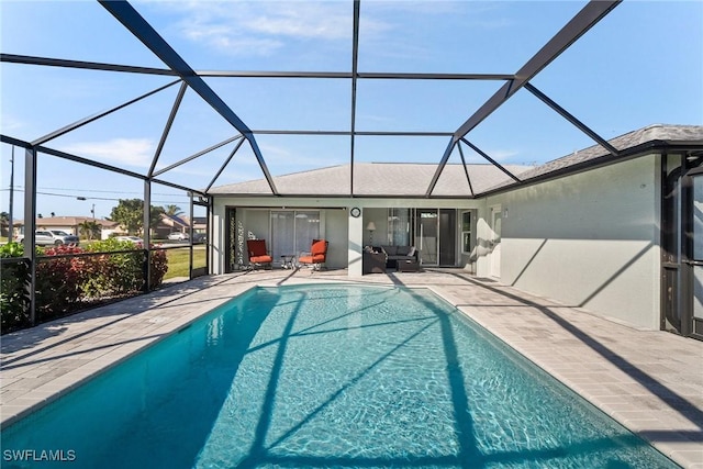 view of swimming pool with a patio and a lanai