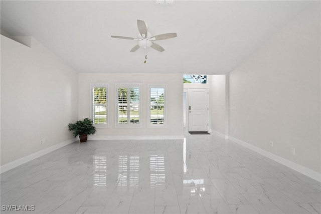 unfurnished living room with ceiling fan and lofted ceiling