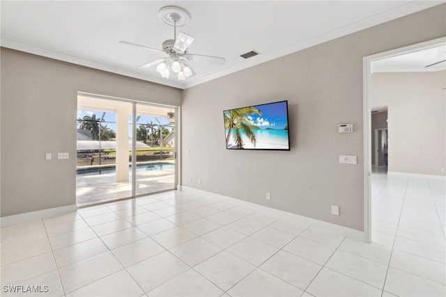 empty room featuring a ceiling fan, crown molding, and light tile patterned floors