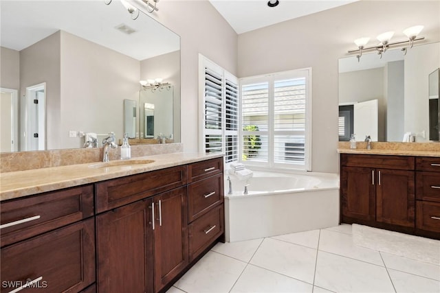 bathroom with a garden tub, two vanities, a sink, and tile patterned floors