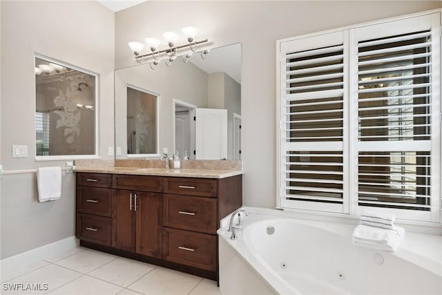 full bathroom with baseboards, vanity, a tub with jets, and tile patterned floors