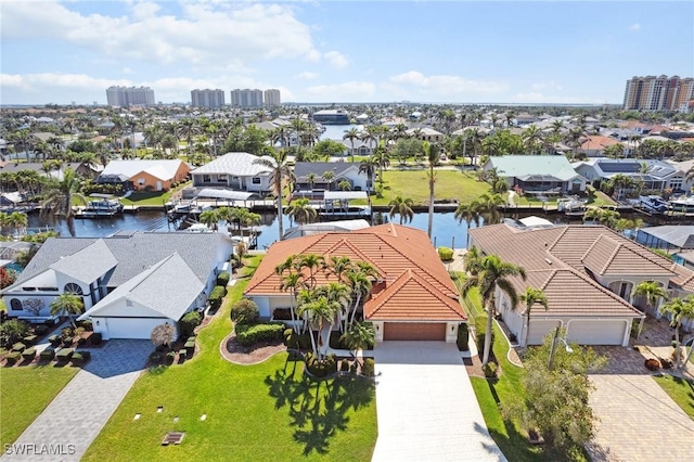 drone / aerial view with a water view and a residential view