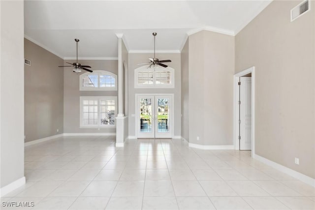 spare room featuring baseboards, visible vents, ceiling fan, ornamental molding, and french doors