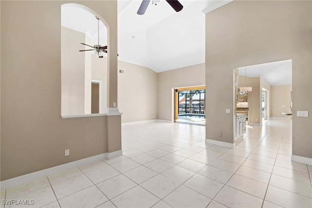 spare room featuring light tile patterned floors, ceiling fan, high vaulted ceiling, and baseboards