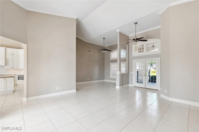 unfurnished living room with ornamental molding, french doors, baseboards, and light tile patterned floors