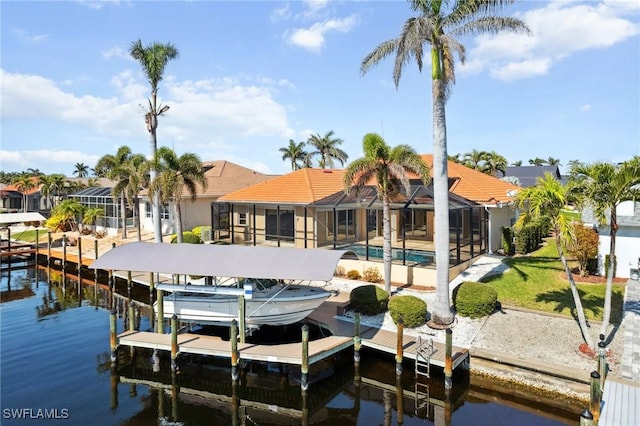 view of dock featuring glass enclosure, boat lift, a water view, a residential view, and an outdoor pool