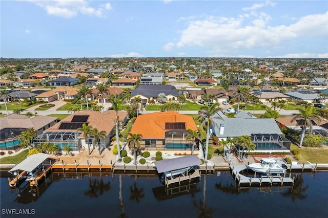 bird's eye view featuring a water view and a residential view