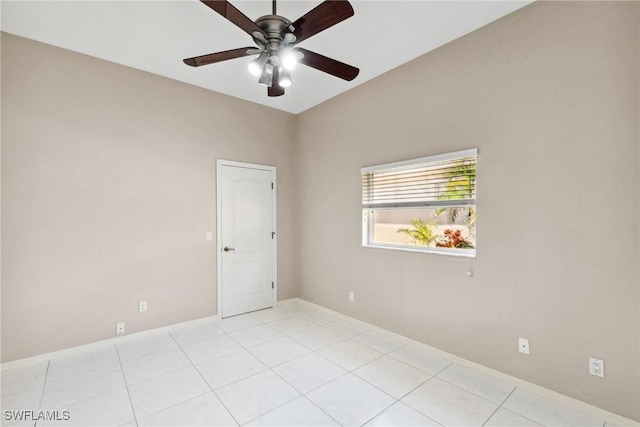 spare room with light tile patterned floors, ceiling fan, and baseboards