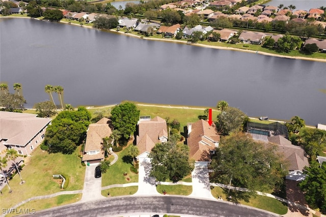 drone / aerial view featuring a water view and a residential view