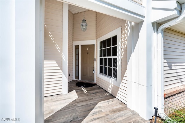 view of exterior entry featuring brick siding