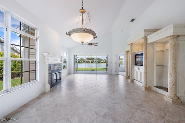 unfurnished living room with high vaulted ceiling, decorative columns, visible vents, and a high end fireplace