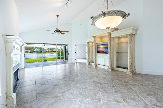 unfurnished living room featuring decorative columns, ceiling fan, tile patterned floors, high vaulted ceiling, and a high end fireplace