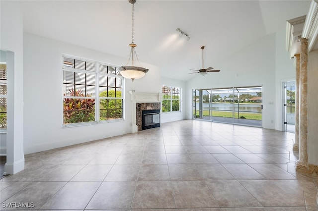 unfurnished living room with a ceiling fan, tile patterned floors, high vaulted ceiling, and a premium fireplace