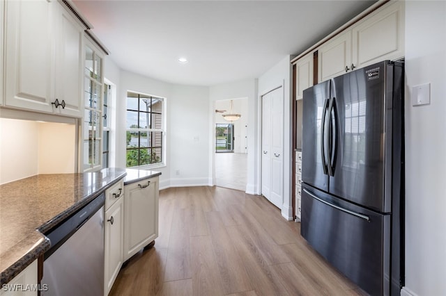 kitchen with baseboards, stainless steel appliances, light wood-style floors, white cabinetry, and recessed lighting