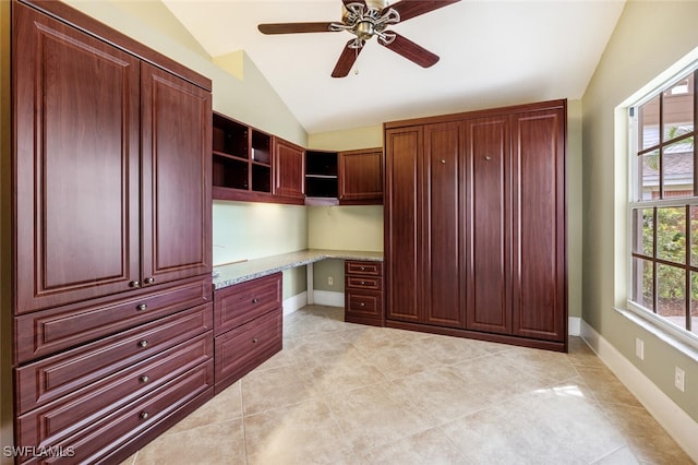 home office with lofted ceiling, plenty of natural light, baseboards, and built in study area