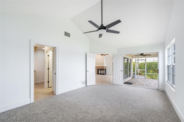 unfurnished room with visible vents, baseboards, ceiling fan, carpet, and high vaulted ceiling