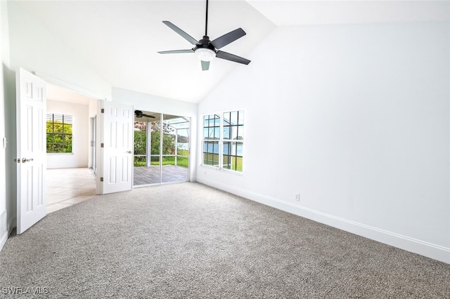 spare room with baseboards, carpet, high vaulted ceiling, and a ceiling fan