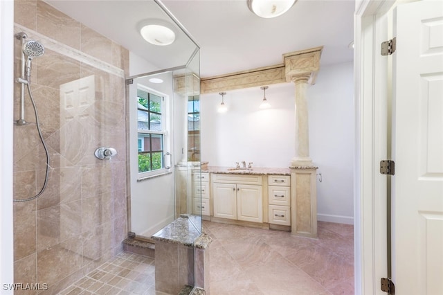 full bathroom featuring a stall shower, baseboards, and vanity