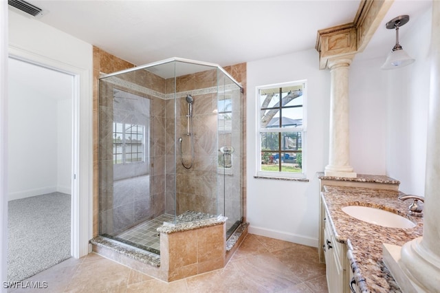 full bath with a stall shower, decorative columns, and visible vents