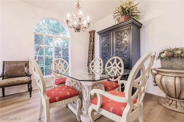 dining room featuring hardwood / wood-style floors and a notable chandelier