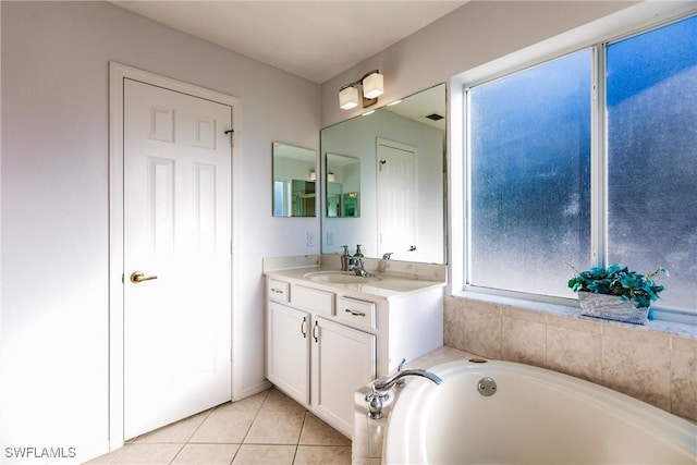 bathroom with vanity, a tub to relax in, and tile patterned floors