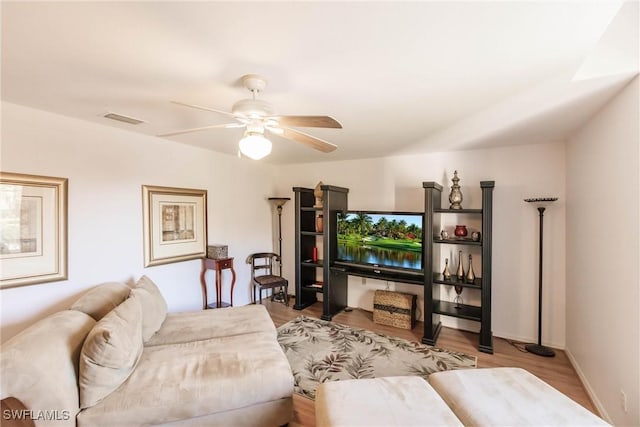 living room with ceiling fan and light wood-type flooring