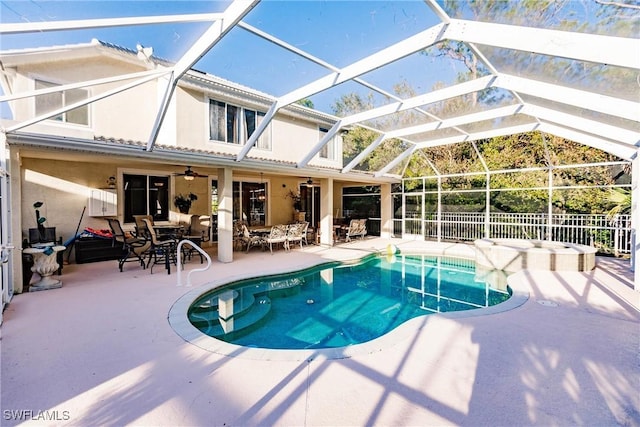 view of pool with a patio area, ceiling fan, and glass enclosure