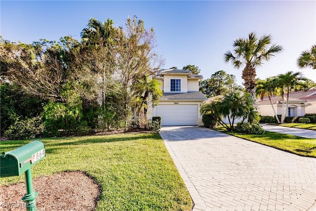 view of front of property with a garage and a front yard