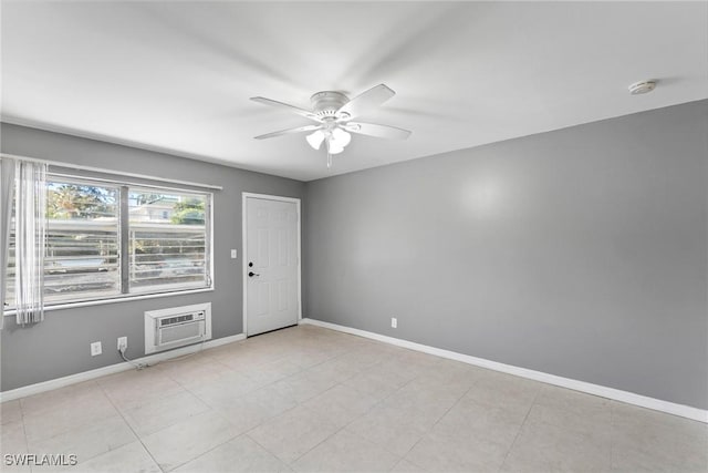 spare room featuring light tile patterned floors, an AC wall unit, and ceiling fan