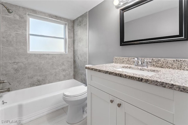 full bathroom featuring vanity, tile patterned flooring, tiled shower / bath combo, and toilet