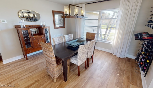 dining room featuring hardwood / wood-style floors and a notable chandelier