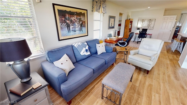 living room with plenty of natural light and light hardwood / wood-style flooring