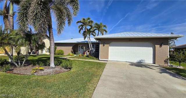 view of front of home with a garage and a front yard