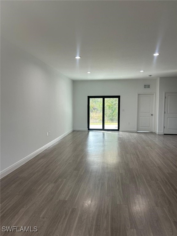 empty room featuring dark hardwood / wood-style flooring