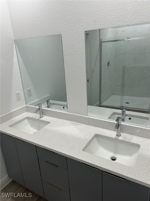 bathroom featuring vanity, wood-type flooring, and an enclosed shower