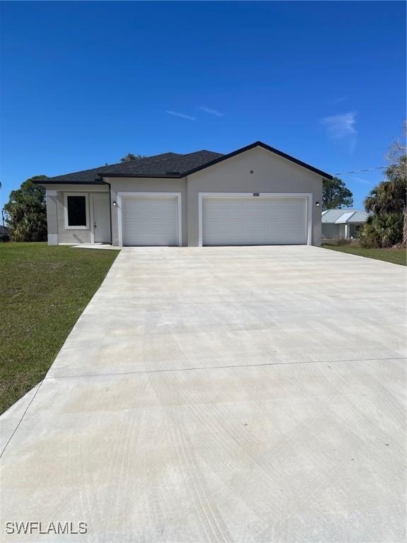 view of front of home featuring a garage and a front lawn