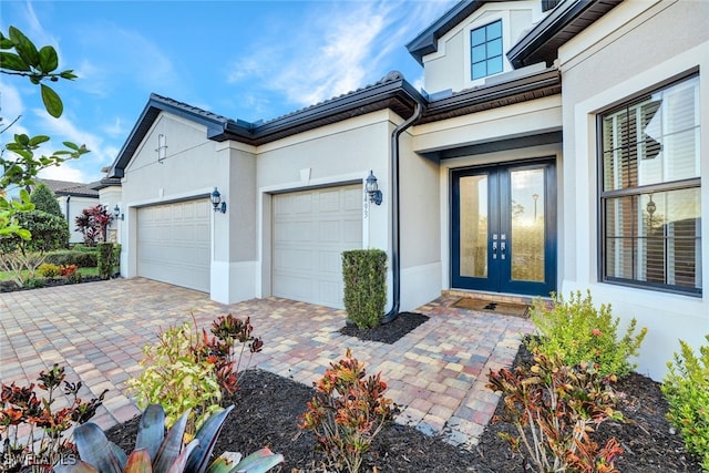 exterior space with french doors and a garage