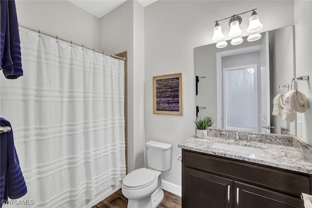 bathroom with hardwood / wood-style flooring, vanity, and toilet