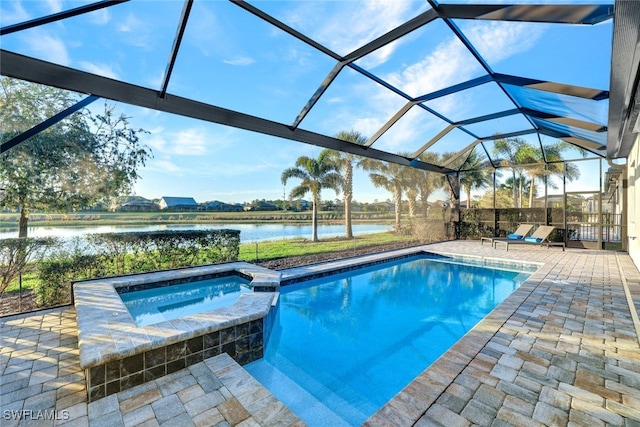 view of pool featuring a patio area, an in ground hot tub, glass enclosure, and a water view